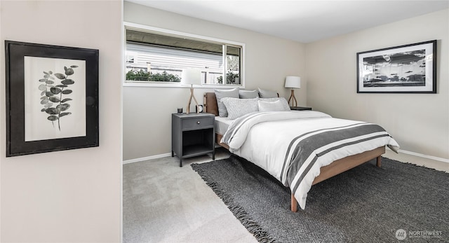 bedroom featuring baseboards and carpet