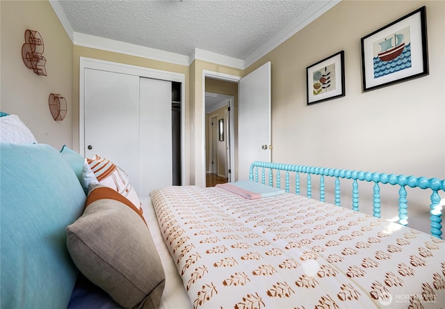 bedroom featuring ornamental molding, a closet, and a textured ceiling