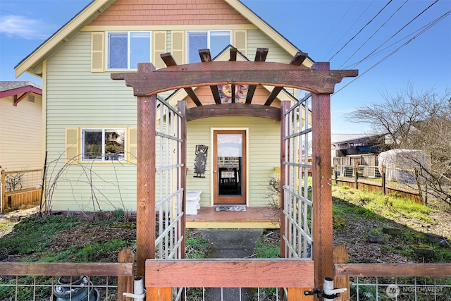 entrance to property featuring fence