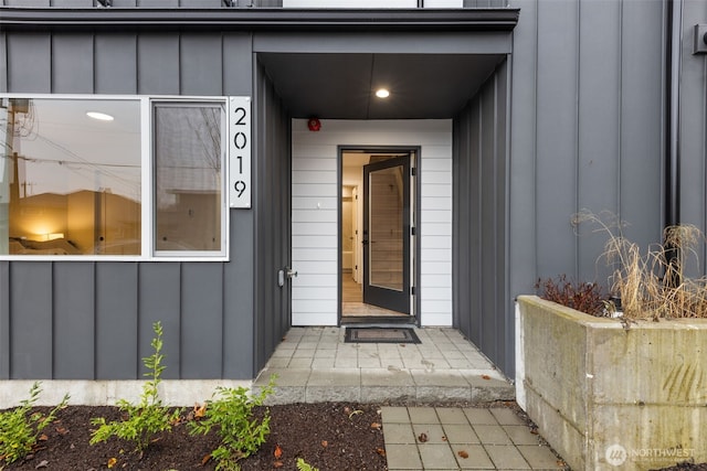 view of exterior entry featuring board and batten siding