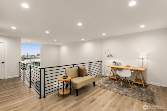 interior space featuring baseboards, wood finished floors, and recessed lighting