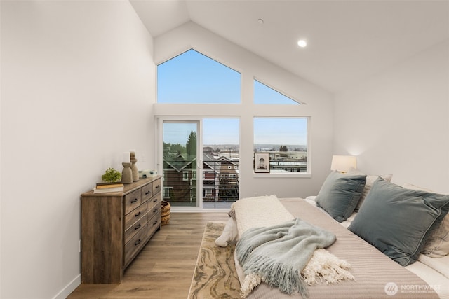 bedroom featuring light wood-type flooring, baseboards, high vaulted ceiling, and recessed lighting