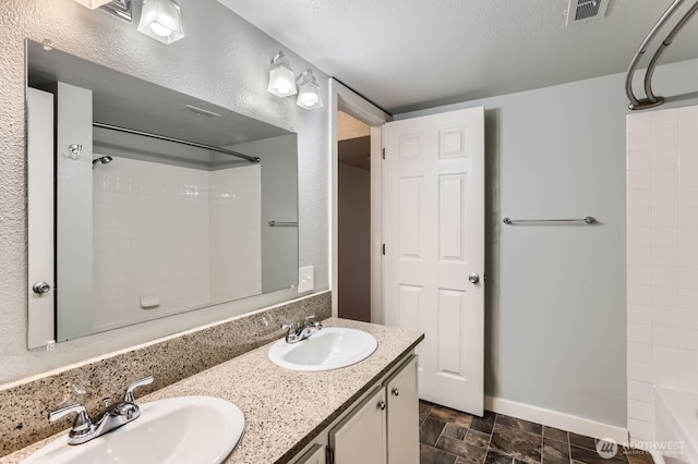 full bathroom with bathtub / shower combination, a sink, visible vents, and baseboards