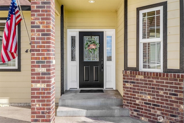 property entrance with brick siding