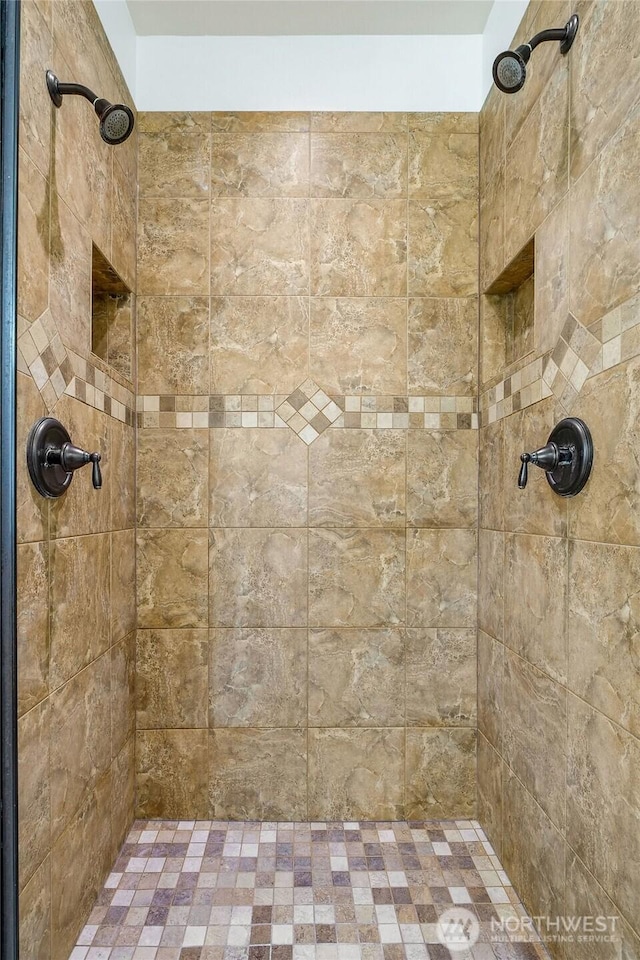 full bath featuring tiled shower