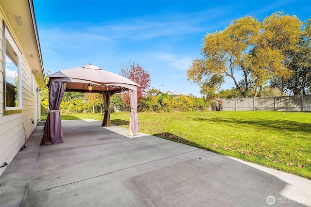 view of patio with fence and a gazebo