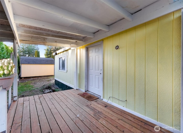 deck featuring a storage shed and an outbuilding