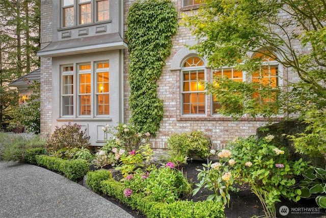 entrance to property featuring brick siding