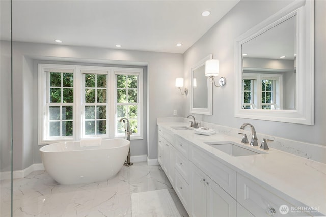 bathroom featuring marble finish floor, a sink, and recessed lighting