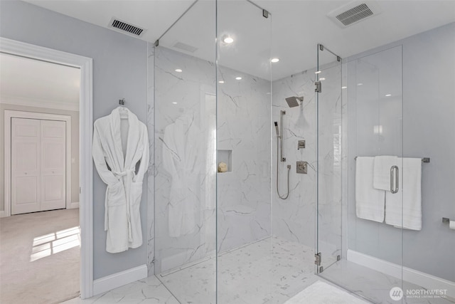 bathroom with a marble finish shower and visible vents