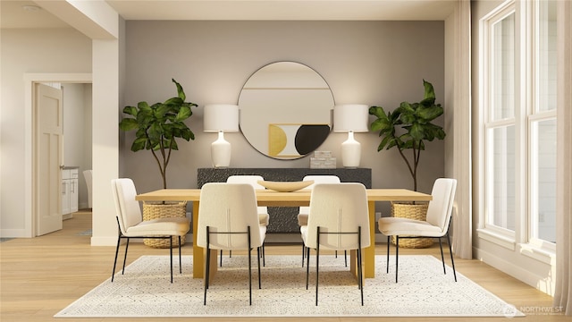 dining area with baseboards and wood finished floors