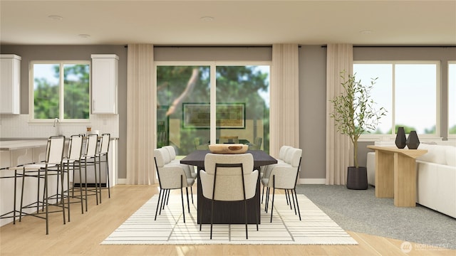 dining area featuring light wood-style flooring