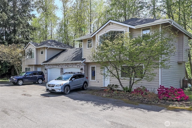 view of front of property with aphalt driveway and an attached garage