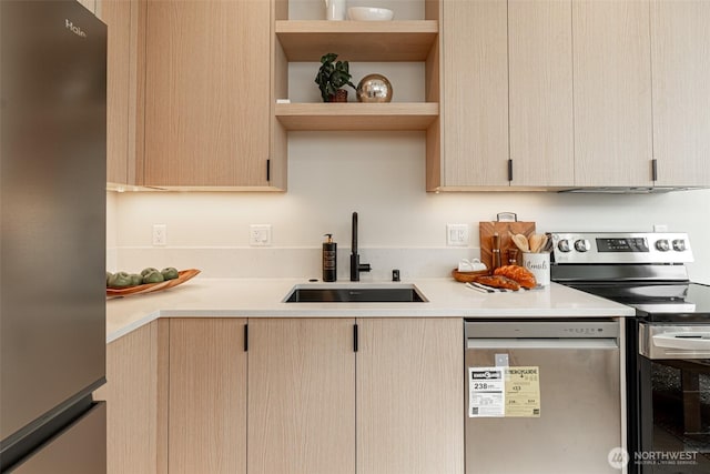 kitchen with light brown cabinets, stainless steel appliances, a sink, light countertops, and open shelves