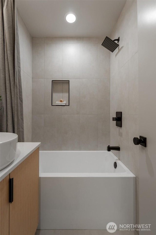 full bath with vanity, tile walls, and shower / bathtub combination with curtain