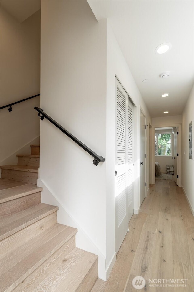 stairs featuring baseboards and wood finished floors