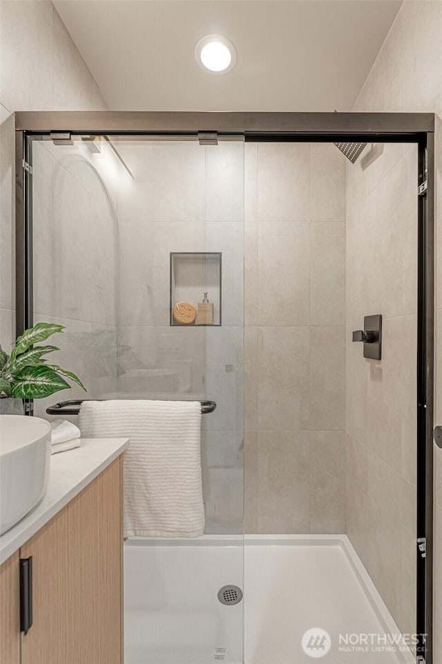 full bathroom featuring a shower stall and vanity