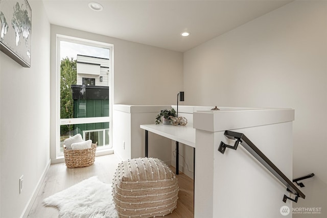 sitting room with baseboards, wood finished floors, an upstairs landing, and recessed lighting