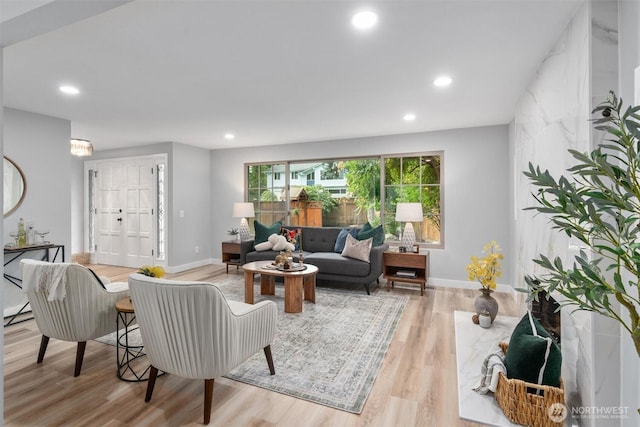 living room with recessed lighting, baseboards, and wood finished floors