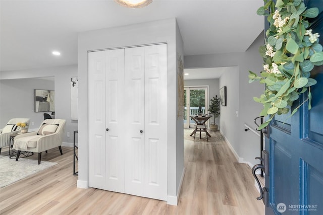 foyer with recessed lighting, light wood-style flooring, and baseboards