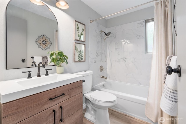 bathroom featuring vanity, toilet, wood finished floors, and shower / bath combo with shower curtain