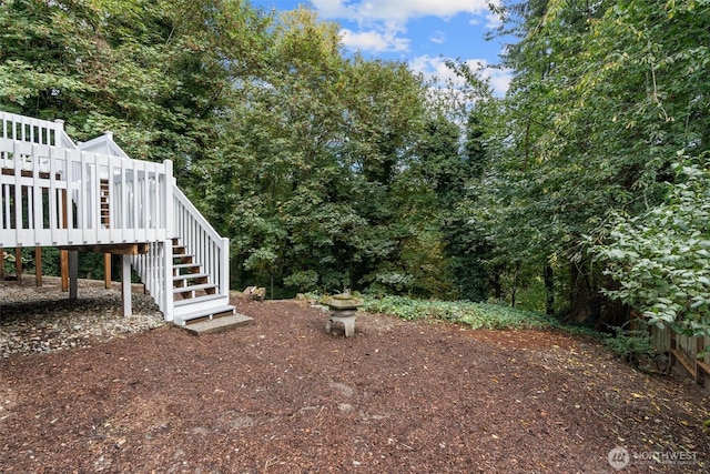 view of yard featuring stairway and a wooden deck