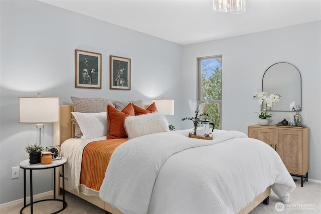 bedroom featuring baseboards and light carpet