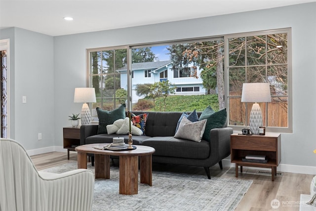 living area featuring recessed lighting, wood finished floors, and baseboards