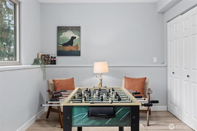 game room featuring wood finished floors and baseboards