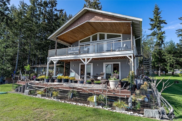 back of house featuring a balcony, a patio area, stairs, and a lawn