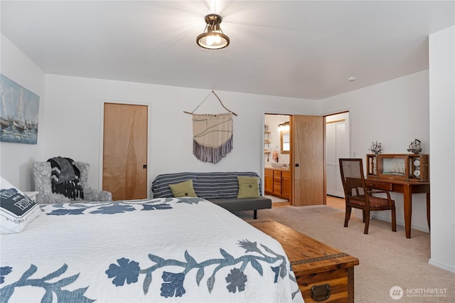 bedroom featuring light carpet, baseboards, and ensuite bathroom