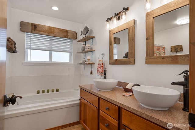 full bath featuring double vanity, a sink, a bath, and recessed lighting