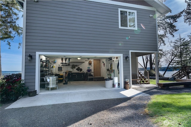 exterior space featuring driveway, stairway, and an attached garage