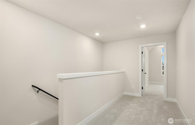 hall featuring recessed lighting, carpet flooring, an upstairs landing, and baseboards