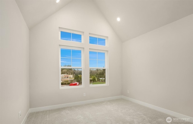 spare room with light carpet, high vaulted ceiling, recessed lighting, and baseboards