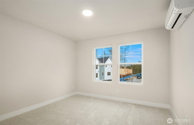 unfurnished room featuring carpet, baseboards, and a wall mounted air conditioner