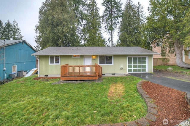 back of house with aphalt driveway, crawl space, and a lawn