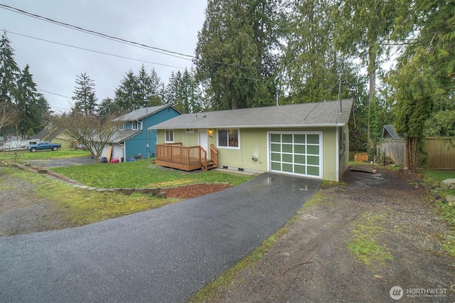 view of front of property featuring a garage, aphalt driveway, crawl space, fence, and a front yard