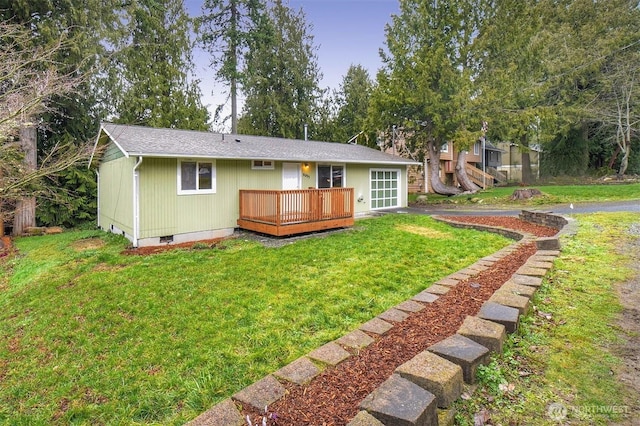 back of house featuring a deck, crawl space, and a lawn