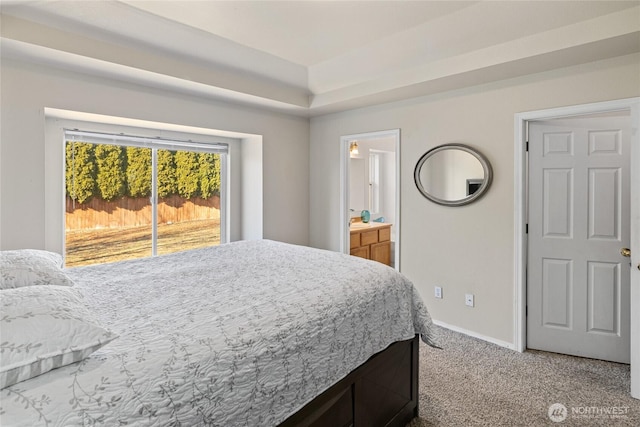 bedroom with carpet floors, ensuite bath, access to outside, and baseboards