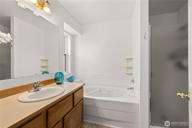 full bath with a shower stall, vanity, and a bath