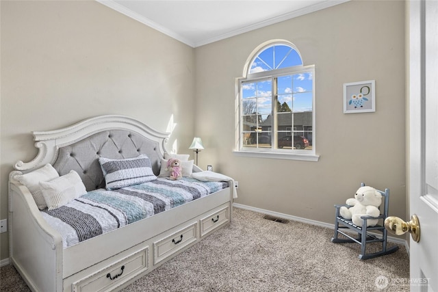 carpeted bedroom with baseboards, visible vents, and crown molding