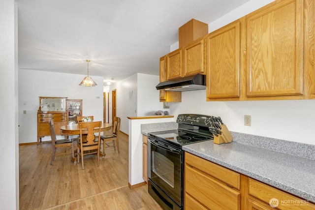 kitchen featuring black range with electric cooktop, under cabinet range hood, baseboards, light wood-style floors, and hanging light fixtures