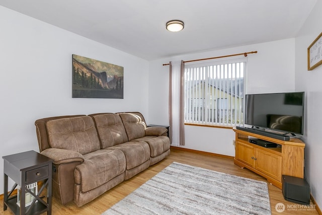 living room with light wood-style flooring and baseboards