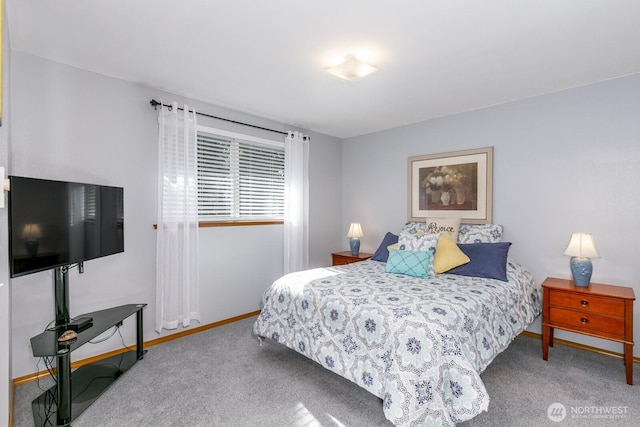 bedroom with carpet flooring and baseboards