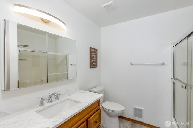 bathroom with toilet, a shower with door, and visible vents