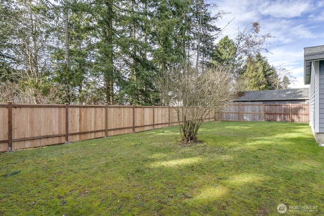 view of yard with a fenced backyard