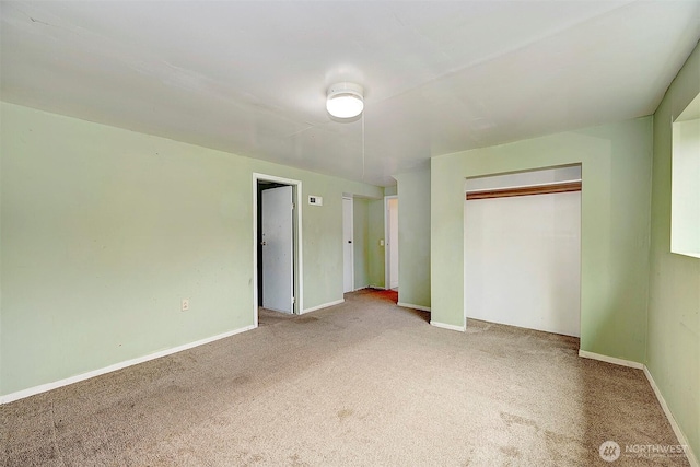 unfurnished bedroom featuring a closet, carpet, and baseboards