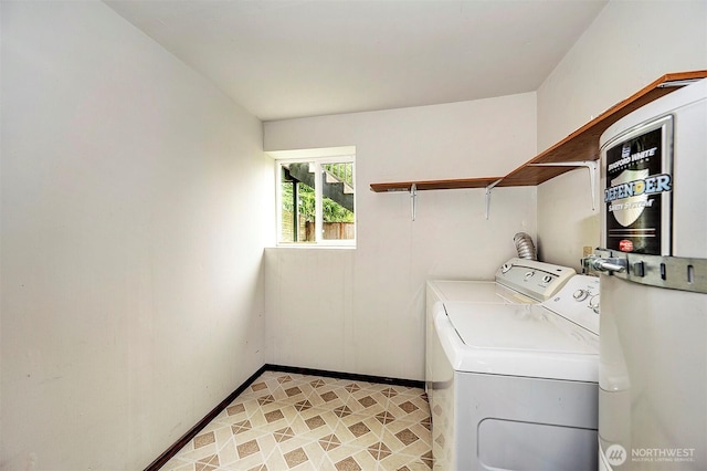 washroom with laundry area, independent washer and dryer, and baseboards