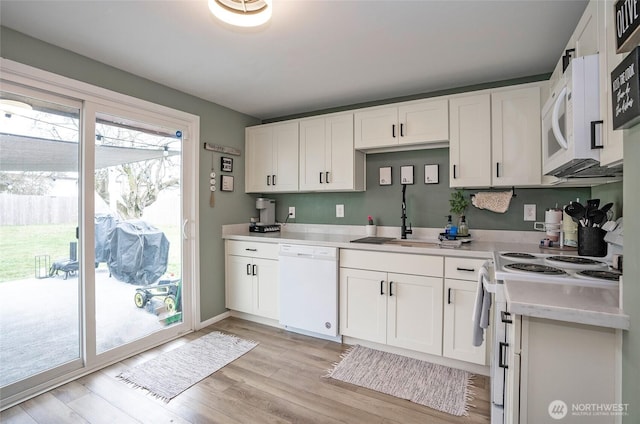 10103 Kline St SW, Lakewood, WA 98499 - kitchen with white appliances, light countertops, light wood finished floors, and white cabinets
